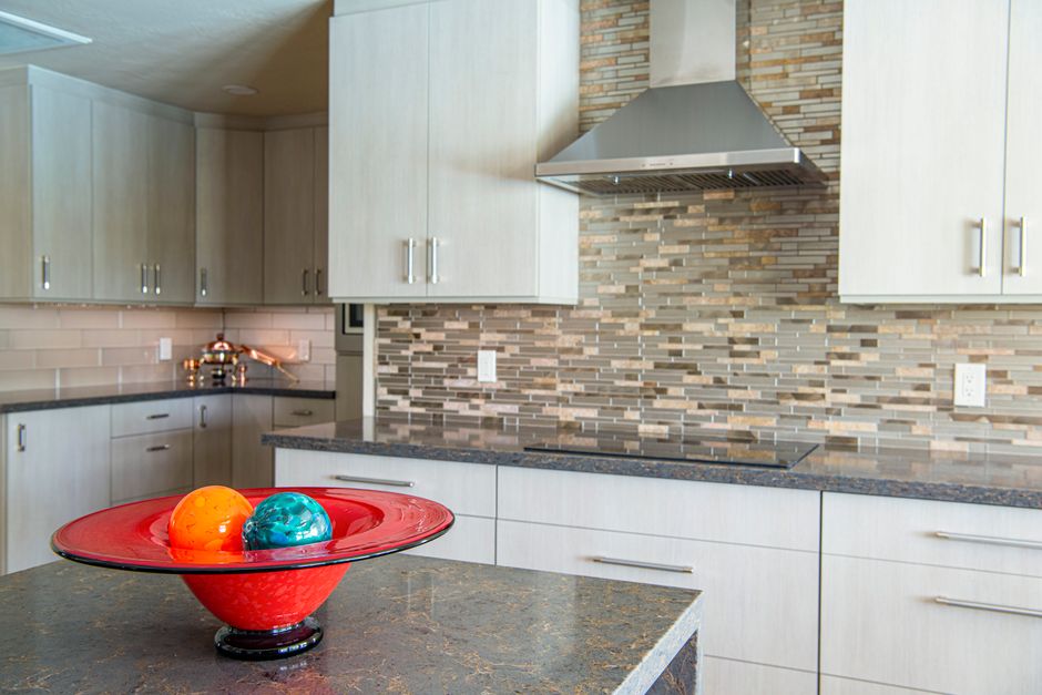 Kitchen with stone countertops and white cabinets.