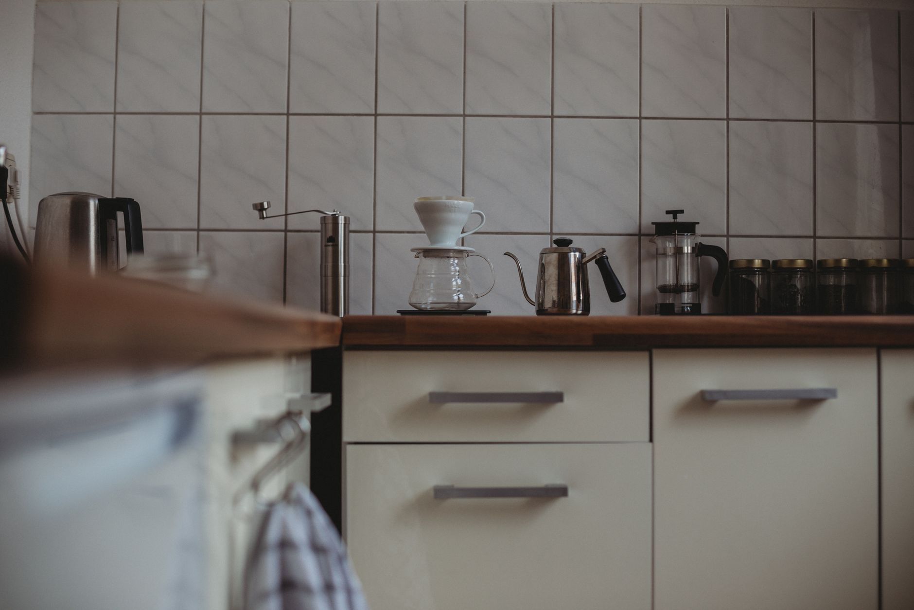A cozy modern kitchen interior featuring various coffee-making equipment on the counter in Austin, TX